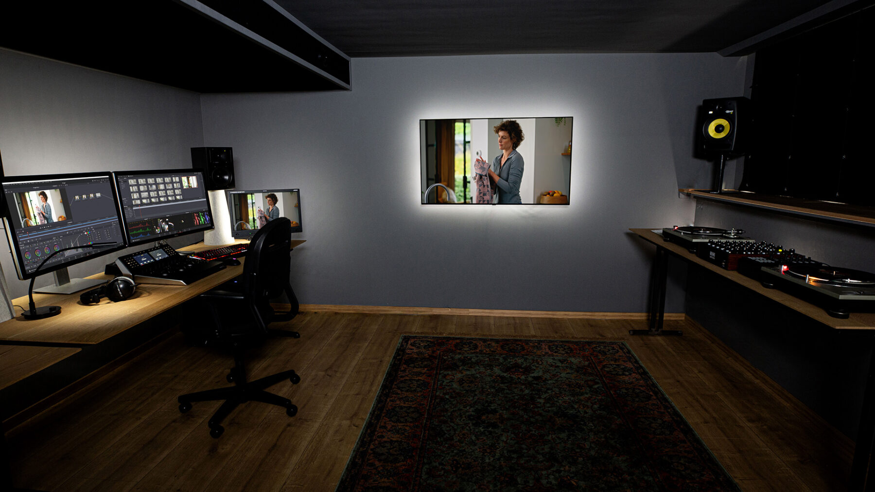 Color grading suite with grey painted walls, reference monitors and a control panel